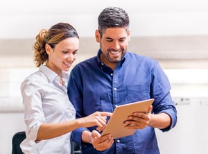 people looking at iPad, as a concept of app development services in San Francisco