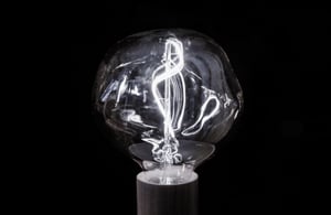 Light bulb on black background, as a concept of rapid application development