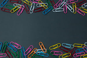paper clips on black paper background as a concept of design sprints