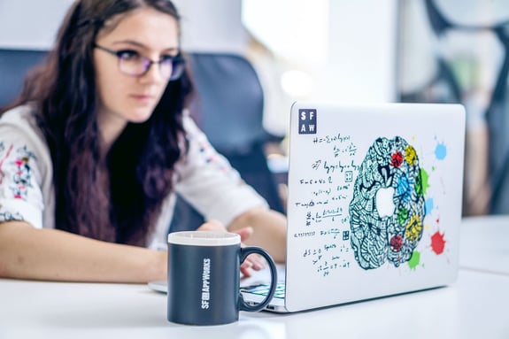 young woman looking at computer, as a concept of software innovation services in San Francisco